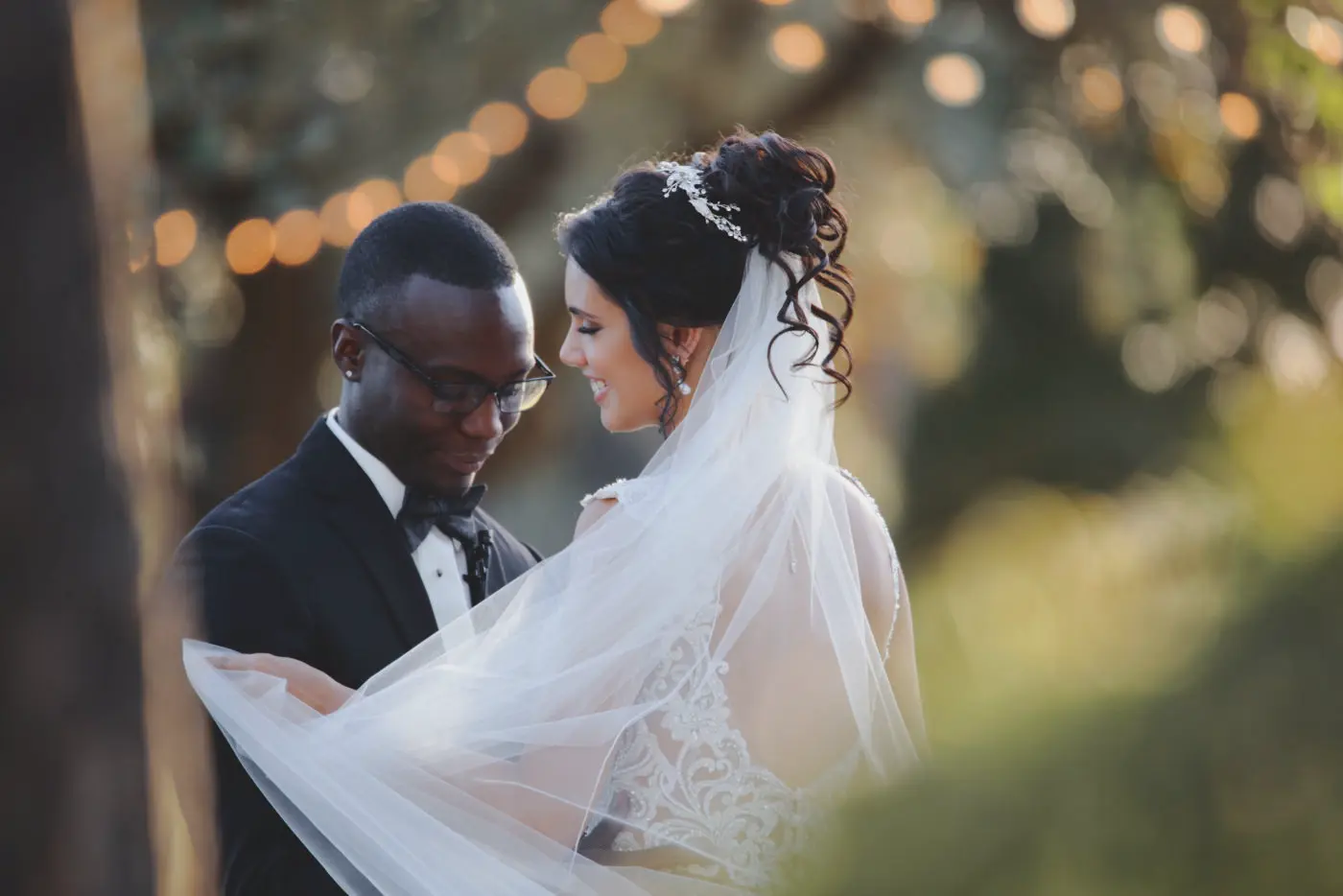 Classic Gold Filmic example: bride and groom embracing under string lights