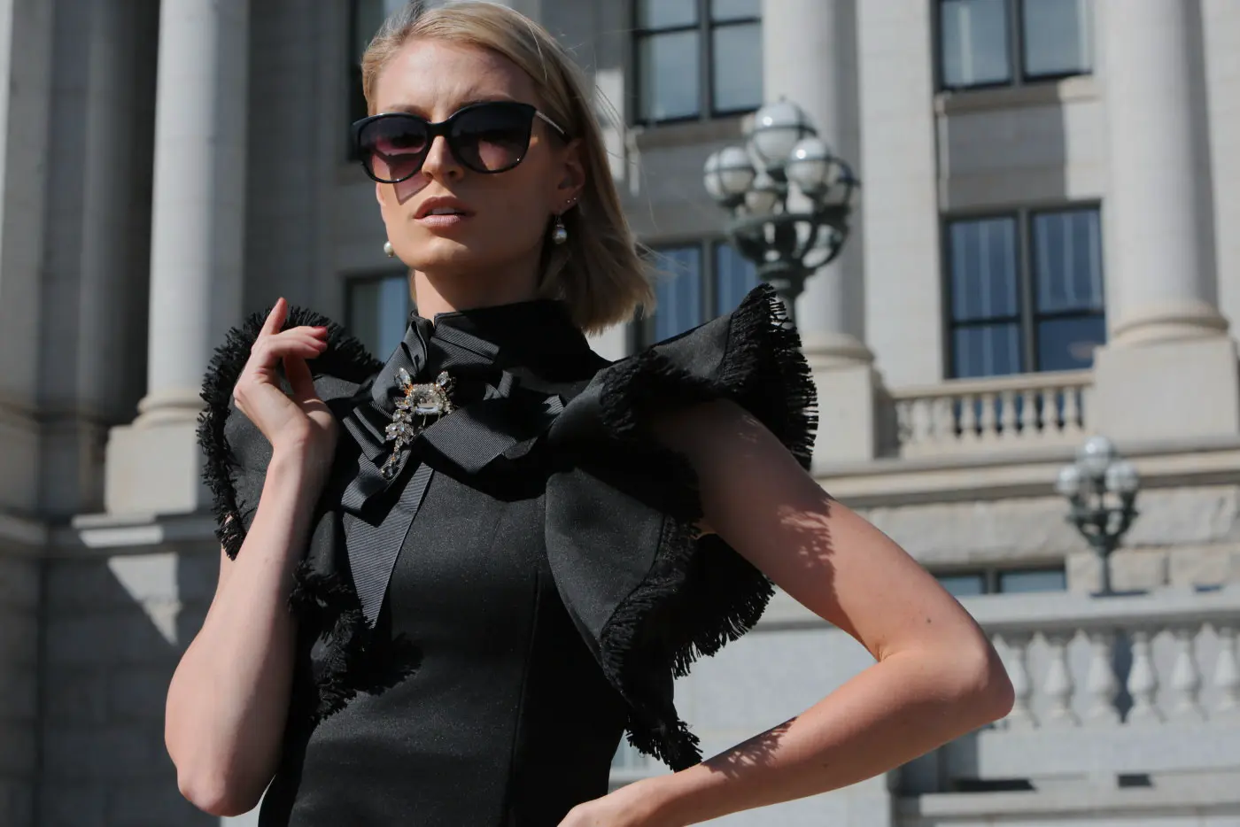 Classic Gold example: woman in sunglasses outside a columned building
