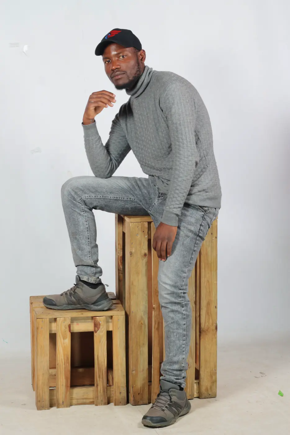 Portrait man gray clothes boxes