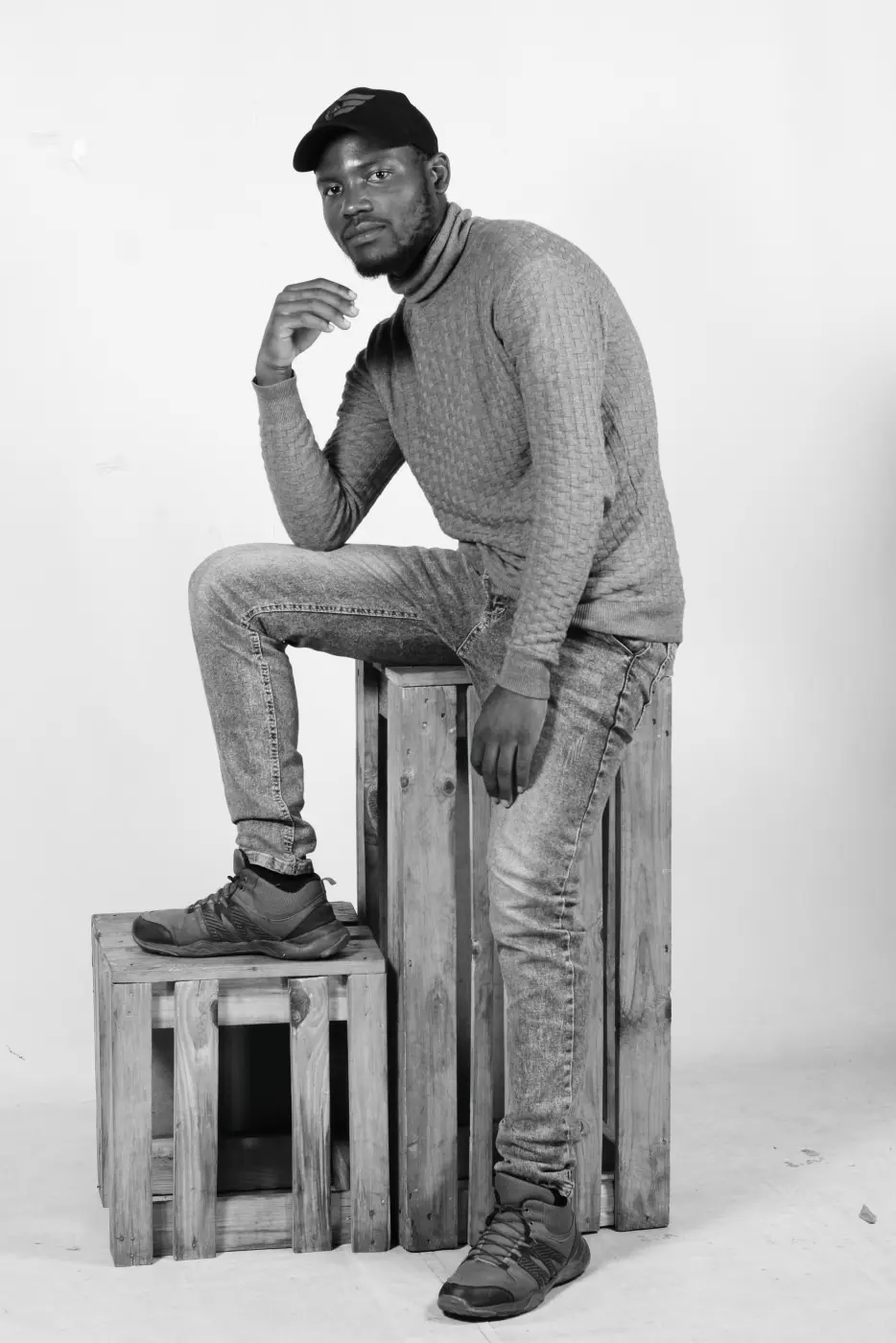 Portrait man gray clothes boxes
