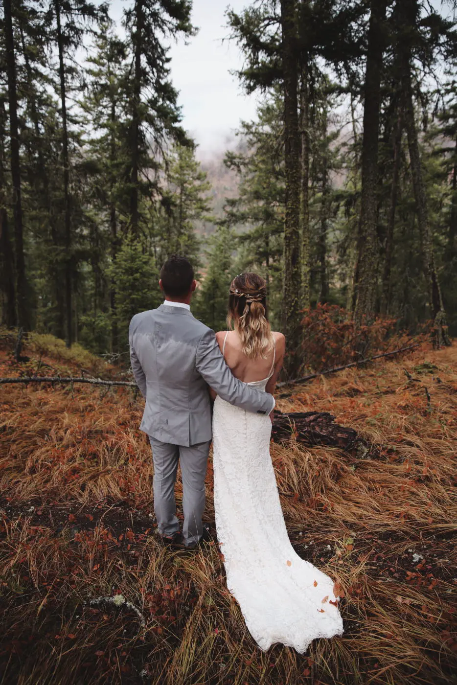 Wedding couple backs woods